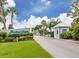 Inviting community entrance with manicured lawns, vibrant landscaping, and a guard house at 798 Fairmount Dr, North Port, FL 34287