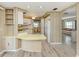 Kitchen with yellow countertops and white cabinets; adjoins dining area and living room at 798 Fairmount Dr, North Port, FL 34287
