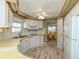 Kitchen with white appliances and cabinets, as well as luxury vinyl flooring at 798 Fairmount Dr, North Port, FL 34287