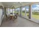 Enclosed lanai offers waterfront views, a ceiling fan, and a dining table at 798 Fairmount Dr, North Port, FL 34287
