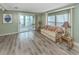 Bright living room features wood-look floors, and sliding glass doors to the screened lanai at 798 Fairmount Dr, North Port, FL 34287
