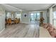 Open-concept living room and dining area filled with natural light and neutral decor at 798 Fairmount Dr, North Port, FL 34287