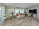 Bright living room featuring wood-look flooring and a comfortable seating area at 798 Fairmount Dr, North Port, FL 34287