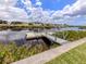 Picturesque waterfront featuring a private dock and canal views under a sunny sky at 798 Fairmount Dr, North Port, FL 34287