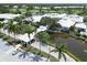 Aerial view of the community clubhouse, waterway, and manicured landscaping at 819 Montrose Dr # 102, Venice, FL 34293