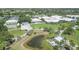 Aerial view showcasing the community with pond, green spaces, and recreational facilities at 819 Montrose Dr # 102, Venice, FL 34293