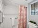 Bathroom shower with safety bars and patterned shower curtain at 819 Montrose Dr # 102, Venice, FL 34293