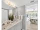 Bathroom with a double sink and a view into the bedroom at 819 Montrose Dr # 102, Venice, FL 34293
