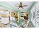 Dining area with rattan seating and backyard views at 819 Montrose Dr # 102, Venice, FL 34293
