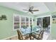 Dining area featuring a glass table and slider with backyard views at 819 Montrose Dr # 102, Venice, FL 34293