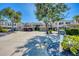 Charming condo exterior featuring carport, lush landscaping, and well-maintained grounds in a desirable community at 819 Montrose Dr # 102, Venice, FL 34293