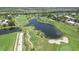 Aerial view of a picturesque golf course featuring serene lakes, lush fairways, and beautiful landscaping at 819 Montrose Dr # 102, Venice, FL 34293