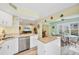 Open kitchen featuring white cabinets, granite counters, and stainless appliances at 819 Montrose Dr # 102, Venice, FL 34293