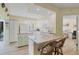 Bright kitchen with granite countertops, island, and white cabinetry at 819 Montrose Dr # 102, Venice, FL 34293
