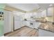 Bright kitchen featuring white cabinets, granite counters, and an island at 819 Montrose Dr # 102, Venice, FL 34293
