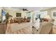 Spacious open-concept living room with hardwood floors, comfortable seating, and a seamless flow to the kitchen at 819 Montrose Dr # 102, Venice, FL 34293