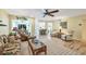 Spacious living room featuring wood floors, ceiling fan, and comfortable seating at 819 Montrose Dr # 102, Venice, FL 34293