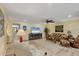Comfortable living room with natural light, modern ceiling fan, and stylish decor for a relaxed atmosphere at 819 Montrose Dr # 102, Venice, FL 34293