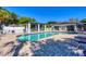 Relaxing outdoor pool area with shade, plenty of lounge chairs, and brick paver deck at 819 Montrose Dr # 102, Venice, FL 34293