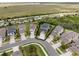 Aerial view shows a home in a neighborhood with lush landscaping, well-manicured lawns, and neutral color palettes at 8304 Shooting Star Rd, Sarasota, FL 34241