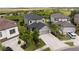 An aerial view captures this home with a well-manicured yard, lush landscaping, and neutral color palette at 8304 Shooting Star Rd, Sarasota, FL 34241