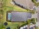 Aerial view shows a fenced yard, a pool with an enclosed screen, a trampoline, and a manicured lawn at 8304 Shooting Star Rd, Sarasota, FL 34241