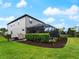 The backyard features a screened pool, manicured lawn, and lush landscaping at 8304 Shooting Star Rd, Sarasota, FL 34241