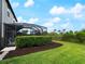 Beautiful backyard with a pool, manicured lawn, mature hedges and landscaping at 8304 Shooting Star Rd, Sarasota, FL 34241
