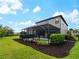 Expansive backyard with a screened lanai, pool, and lush landscaping at 8304 Shooting Star Rd, Sarasota, FL 34241