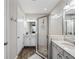 Bright bathroom featuring double sinks, granite countertops and glass shower with stone flooring at 8304 Shooting Star Rd, Sarasota, FL 34241