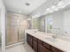 Bathroom featuring a large glass enclosed shower, double sinks, and modern fixtures at 8304 Shooting Star Rd, Sarasota, FL 34241