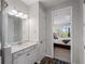 Bathroom with granite countertops, modern fixtures, and wood-style floors, adjacent to the bedroom at 8304 Shooting Star Rd, Sarasota, FL 34241