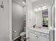 Bathroom featuring granite countertops, modern lighting, and dark wood-style floors at 8304 Shooting Star Rd, Sarasota, FL 34241