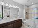 Well-lit bathroom features a double sink vanity, a combination shower and tub, and neutral paint at 8304 Shooting Star Rd, Sarasota, FL 34241
