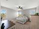 Bright bedroom boasts multiple windows, a ceiling fan, plush carpet and comfortable sleeping space at 8304 Shooting Star Rd, Sarasota, FL 34241