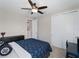 Bright bedroom features a ceiling fan, natural light, and neutral paint and carpet, with a dark wood dresser at 8304 Shooting Star Rd, Sarasota, FL 34241