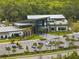 Stunning community clubhouse with modern architecture, ample parking, and lush landscaping at 8304 Shooting Star Rd, Sarasota, FL 34241