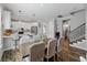Elegant dining space next to the open kitchen, complete with a stylish table and access to stairs at 8304 Shooting Star Rd, Sarasota, FL 34241