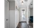 Stylish entryway featuring decorative paneling, wood-look floors, and a view of the front door, creating a lasting impression at 8304 Shooting Star Rd, Sarasota, FL 34241