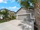 Charming home featuring a two-car garage, manicured lawn, and lush landscaping at 8304 Shooting Star Rd, Sarasota, FL 34241