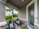 Inviting front porch featuring comfortable seating, attractive decor, and a pleasant outdoor ambiance with lush landscaping at 8304 Shooting Star Rd, Sarasota, FL 34241