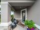 Charming front porch with stylish chairs and a welcoming entrance, perfect for relaxing and enjoying the outdoors at 8304 Shooting Star Rd, Sarasota, FL 34241