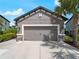 Two car garage features decorative stone accents and carriage style doors at 8304 Shooting Star Rd, Sarasota, FL 34241