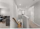 Hallway with carpet, white trim, wood banister, and a view of the living room at 8304 Shooting Star Rd, Sarasota, FL 34241