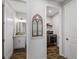 Well-lit hallway leading to a powder room and laundry area with modern fixtures and stylish design elements at 8304 Shooting Star Rd, Sarasota, FL 34241