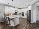 Spacious kitchen with stainless steel appliances, a center island with bar seating, and plenty of counter space at 8304 Shooting Star Rd, Sarasota, FL 34241
