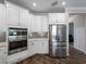 Kitchen with white cabinets, stainless steel appliances, and an abundance of storage for a seamless cooking experience at 8304 Shooting Star Rd, Sarasota, FL 34241