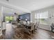 Open-concept living and dining area featuring modern furnishings and stylish decor with access to the outdoor area at 8304 Shooting Star Rd, Sarasota, FL 34241