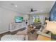 Spacious living area featuring a large TV, comfortable seating, and access to an outdoor area with picturesque views at 8304 Shooting Star Rd, Sarasota, FL 34241