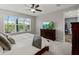 Bright main bedroom with TV and a large window view of the pool at 8304 Shooting Star Rd, Sarasota, FL 34241